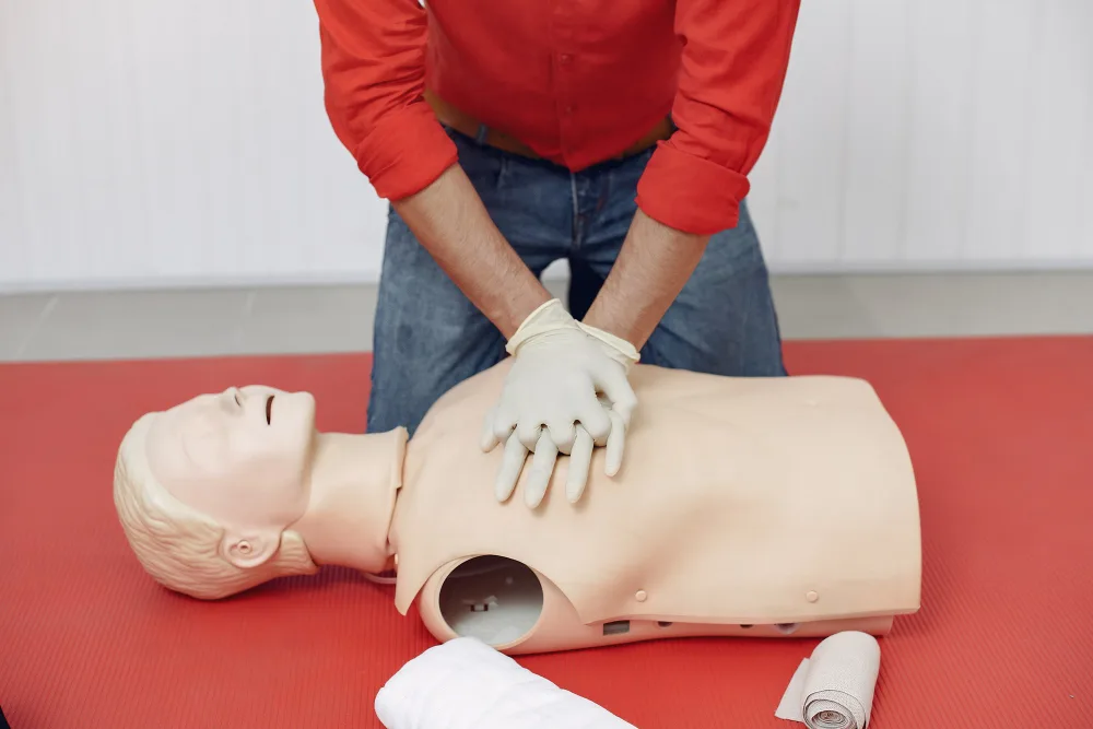 Take A Class 5 Healthcare providers practicing team-based CPR and resuscitation in a Basic Life Support class